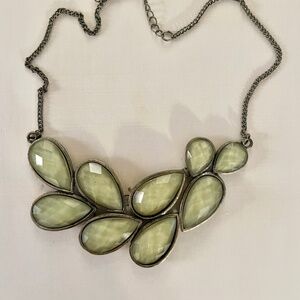 Make a Statement with a "statement necklace" in warm green and aged brass tone.